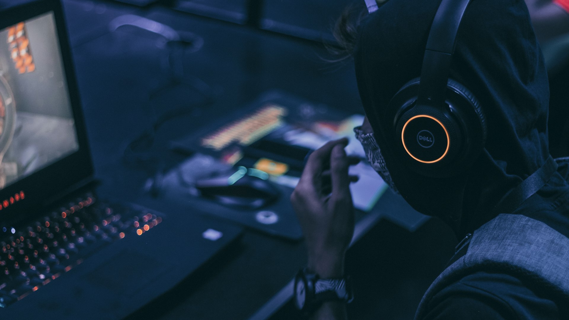Players seated at neon-lit gaming PCs inside Crystal Wild Frontier